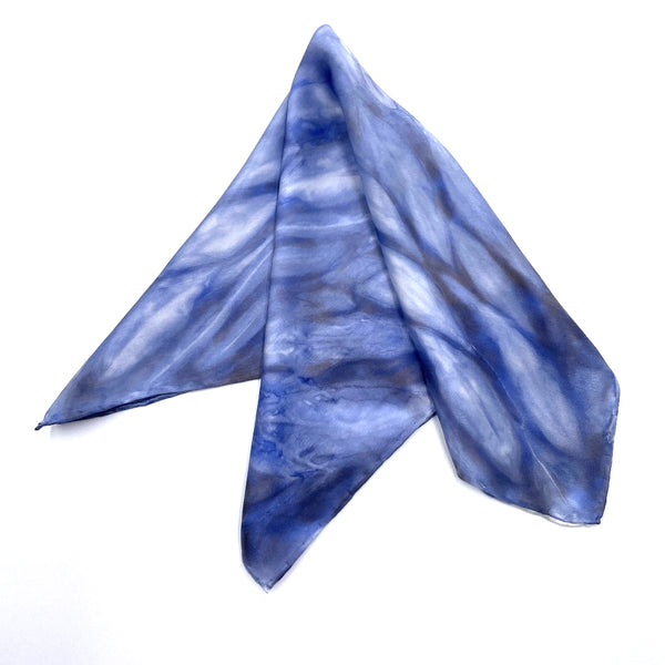 Indigo blue luxury silk pocket square scarf in striped shibori pattern, sustainable wear with many style looks. Best fashion accessory for any season or occasion. Makes a great gift. Handmade one of a kind artisan accessories. Square shaped 17 inches by 17 inches.
