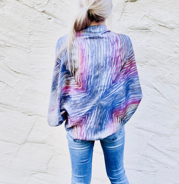 Model is wearing a rainbow multi colored large luxury silk square scarf in striped safari shibori pattern as a jacket tied in front, sustainable wear with many style looks. Best fashion accessory for any season or occasion. Makes a great gift. Handmade one of a kind artisan accessories. Square shaped 43 inches by 43 inches.
