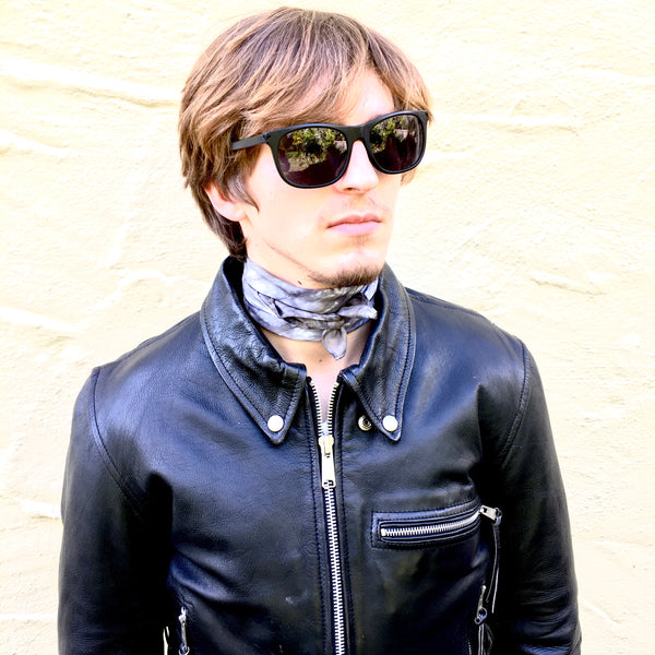 Model is wearing black charcoal luxury silk bandana scarf tied in back, sustainable wear with many style looks. Best fashion accessory for any season or occasion. Makes a great gift. Handmade one of a kind artisan accessories. Square dimension 21 inches by 21 inches.