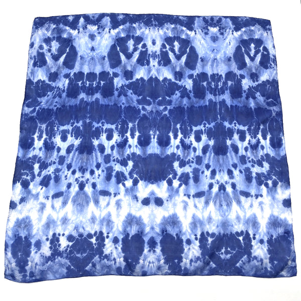 Indigo blue luxury silk bandana scarf in animal ikat shibori pattern, sustainable wear with many style looks. Best fashion accessory for any season or occasion. Makes a great gift. Handmade one of a kind artisan accessories. Square shaped 28 inches by 28 inches.