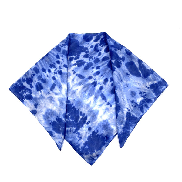 Indigo blue luxury silk bandana scarf in animal ikat shibori pattern, sustainable wear with many style looks. Best fashion accessory for any season or occasion. Makes a great gift. Handmade one of a kind artisan accessories. Square shaped 28 inches by 28 inches.