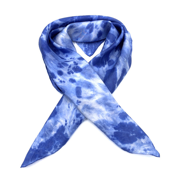 Indigo blue luxury silk bandana scarf in animal ikat shibori pattern, sustainable wear with many style looks. Best fashion accessory for any season or occasion. Makes a great gift. Handmade one of a kind artisan accessories. Square shaped 28 inches by 28 inches.