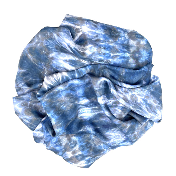 Blue luxury large silk square scarf shawl in tie dye shibori pattern, sustainable wear with many style looks. Best fashion accessory for any season or occasion. Makes a great gift. Handmade one of a kind artisan accessories. Square shaped 43 inches by 43 inches.