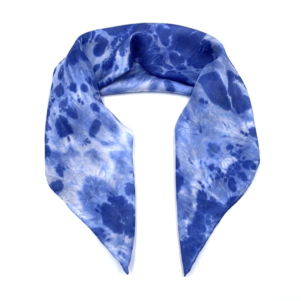 Indigo blue luxury silk bandana scarf in animal ikat shibori pattern, sustainable wear with many style looks. Best fashion accessory for any season or occasion. Makes a great gift. Handmade one of a kind artisan accessories. Square shaped 28 inches by 28 inches.
