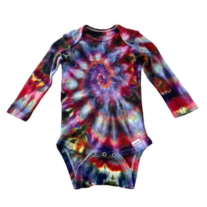 Multi-colored Rainbow spiral swirl hand dyed baby onesie a on a white background. Gender neutral.  Makes a great gift!