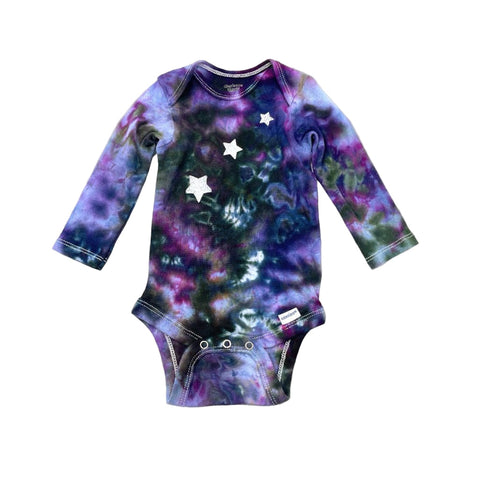 Multi-colored hand dyed baby onesie with star pattern a on a white background. Gender neutral.
