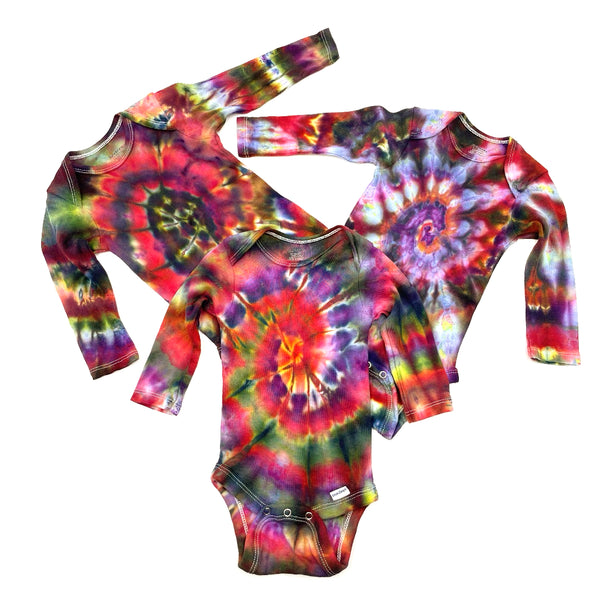 Multi-colored Rainbow spiral swirl hand dyed baby onesie a on a white background. Gender neutral.  Makes a great gift!