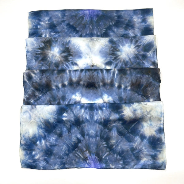 Beautiful handmade 20”x88” hand dyed  100% SUSTAINABLE Rectangular Silk Scarf Shawl with hand rolled hem in various hues of blue, grey and white featuring a mosaic snowflake kaleidoscope design.