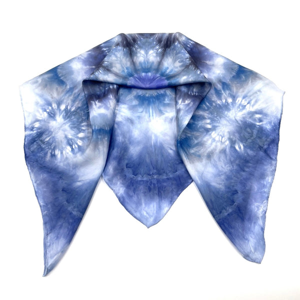 Square blue and white silk scarf measuring 30 inches by 30 inches featuring a geometric eight point circular mandala kaleidoscope pattern. 