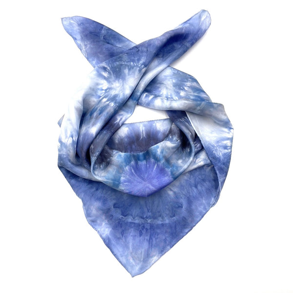 Square blue and white silk scarf measuring 30 inches by 30 inches featuring a geometric eight point circular mandala kaleidoscope pattern. 