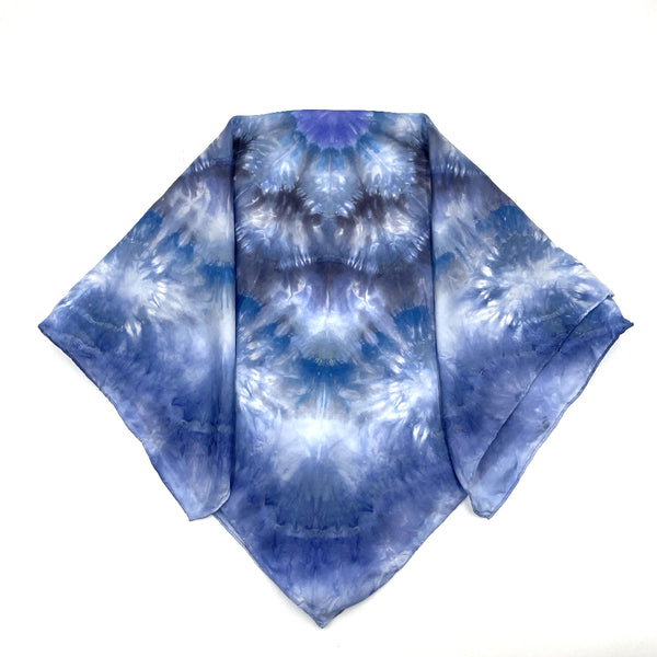 Square blue and white silk scarf measuring 30 inches by 30 inches featuring a geometric eight point circular mandala kaleidoscope pattern. 