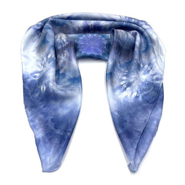 Square blue and white silk scarf measuring 30 inches by 30 inches featuring a geometric eight point circular mandala kaleidoscope pattern. 