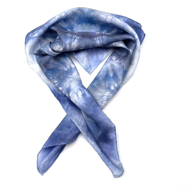 Square blue and white silk scarf measuring 30 inches by 30 inches featuring a geometric eight point circular mandala kaleidoscope pattern. 