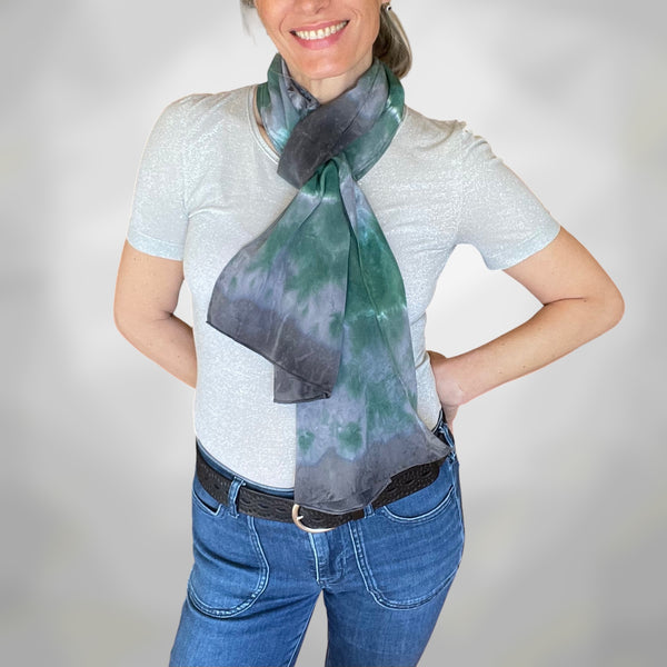 Person wearing a colorful scarf with a plain background