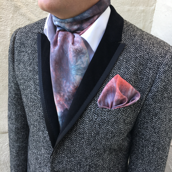 Model is wearing a red platinum luxury silk pocket square in striped shibori pattern, sustainable wear with many style looks. Best fashion accessory for any season or occasion. Makes a great gift. Handmade one of a kind artisan accessories. Square shaped 17 inches by 17 inches.