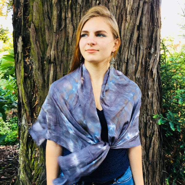 Model is wearing a black charcoal and blue large luxury silk square scarf as a shawl wrap, sustainable wear with many style looks. Best fashion accessory for any season or occasion. Makes a great gift. Handmade one of a kind artisan accessories. Square shaped 43 inches by 43 inches.