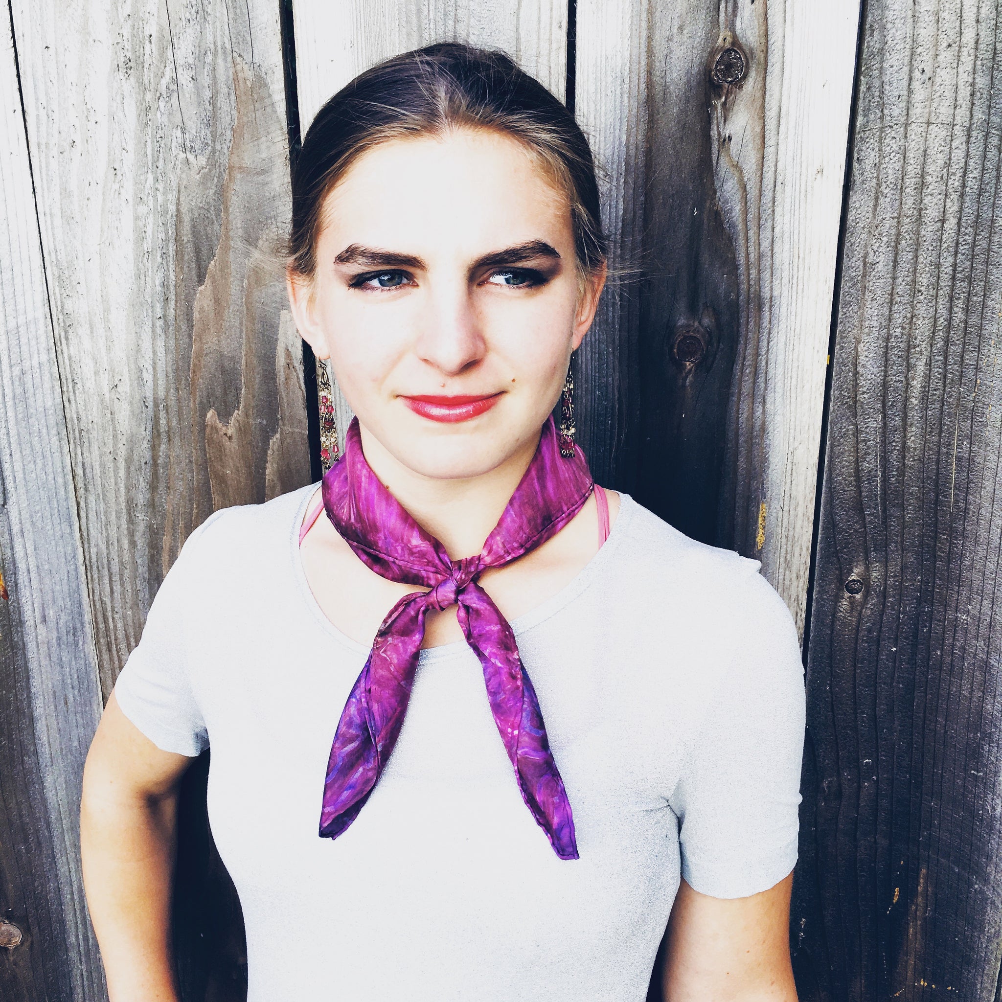 Model is wearing hot pink fuchsia luxury silk bandana scarf tied in front around neck, sustainable wear. Square dimension 21 inches by 21 inches. Best fashion accessory for any season or occasion, and makes a great gift. Handmade artisan one of a kind accessory.